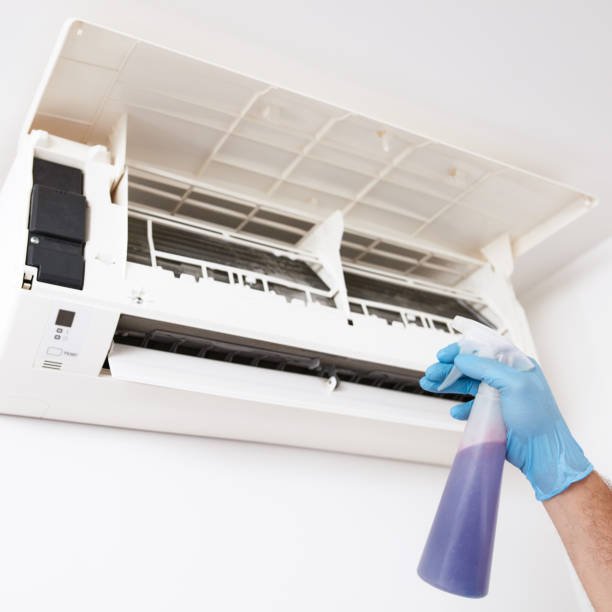 man cleaning and maintaining air condition unit at home.